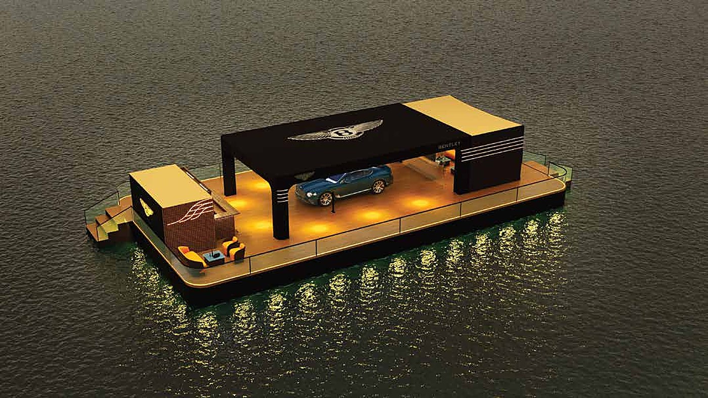 The Bentley GT floating lounge lit up on the water at night