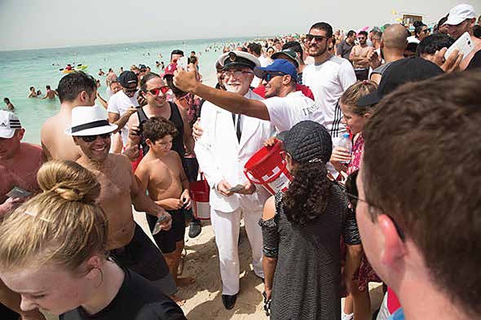 Captain Sanders taking selfies with beachgoers
