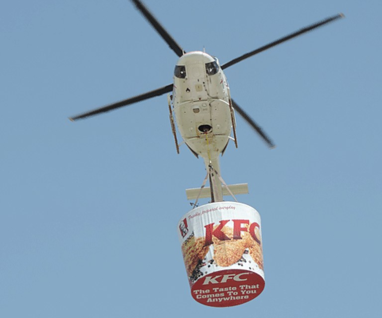 Helicopter lifting a giant KFC bucket
