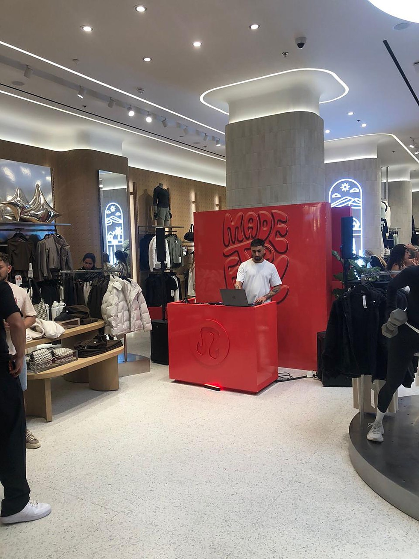 lululemon DJ booth with the red Made to Feel backdrop