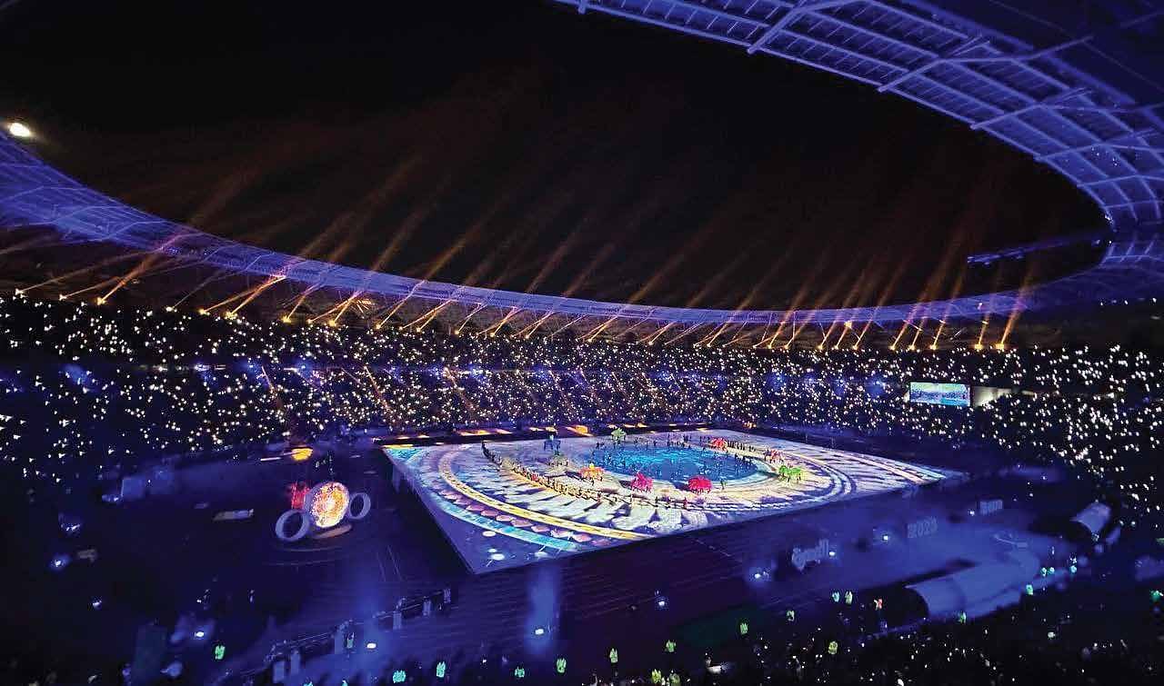 Stadium show with light projection and a full crowd